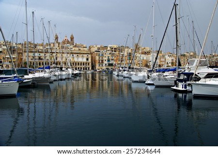 MALTESE ISLAND,EUROPE - NOVEMBER 6, 2014. Gloomy evening in  the Mediterranean Sea on the Maltese  coast ,with ships and yachts  in the harbor.