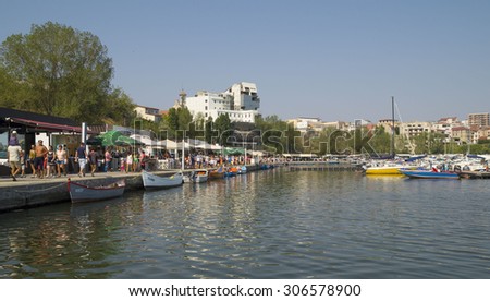 CONSTANTA, ROMANIA - JULY 15, 2015. Leisure time at the cafes and restaurants  on the shore of the Black Sea through the modern yachts and boats in Touristic Tomis Port  in Constanta, Romania.