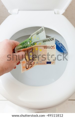 throwing euro money in a toilet bowl