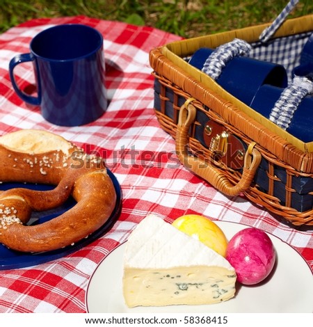 picnic cloth with basket and food on it