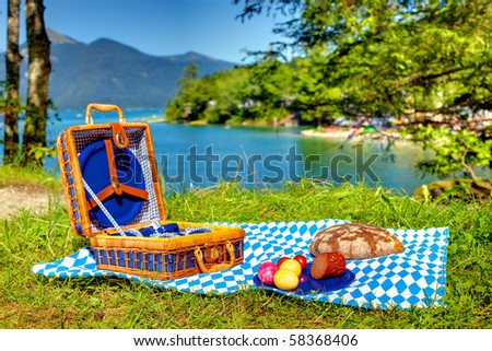 bavarian striped picnic cloth with basket and food on it