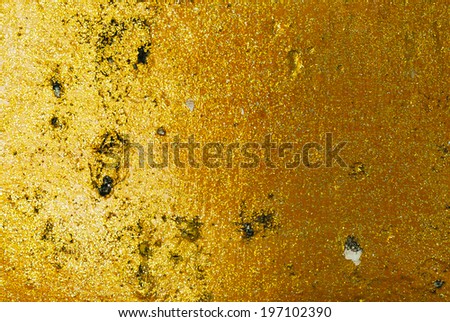 Old gold grunge wall with peeling paint with old concrete