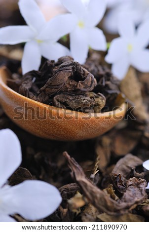 Organic tea jasmine tea with spoon and flowers