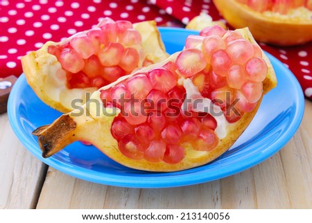 Juicy pomegranate , whole , ripe and cut open