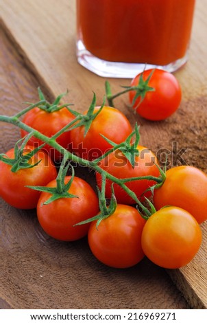 Tomato juice and  cherry tomatoes on the vine