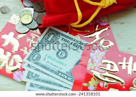 Chinese Red Packet with US Dollar Notes , receiving lucky money packet. Chinese New Year tradition.