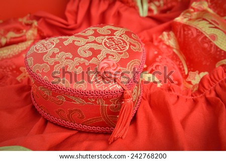 Red and gold box in the shape of a heart and qipao  traditional chinese dress  for chinese new year gift