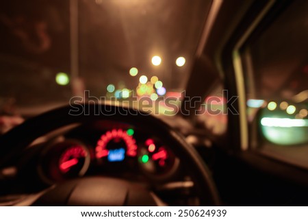 Abstract bokeh of car speed meter light dashboard with traffic  light at night