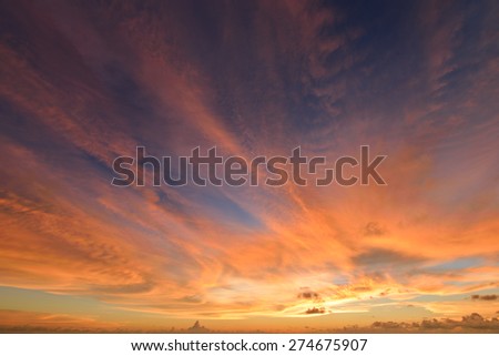 sunset sky with clouds explosion and golden light at ocean ,long exposure
