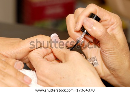 manicurist works on customer nails