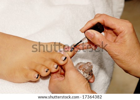 manicurist works on customer nails