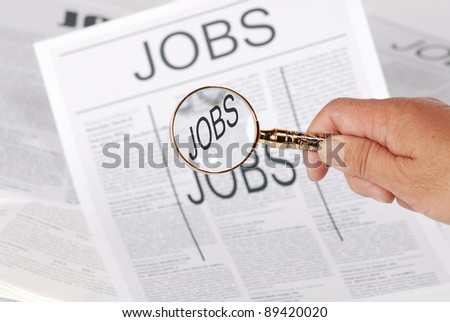 man using magnify looking for jobs