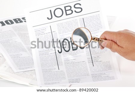 man using magnify looking for jobs