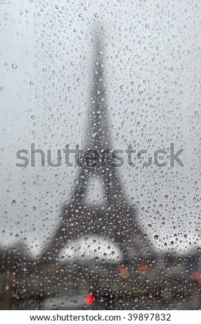 France. Paris. Silhouette of Tour Eiffel through the window with rain drops
