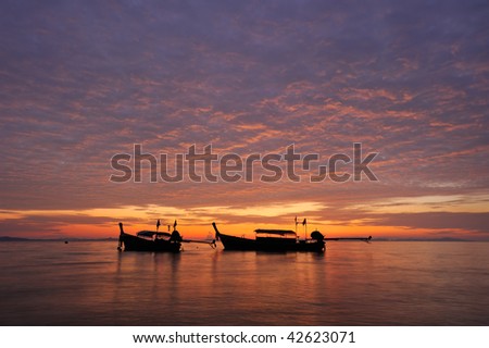 Thailand. Phi Phi island. Magic sunrise landscape with thai boats and colorful sky