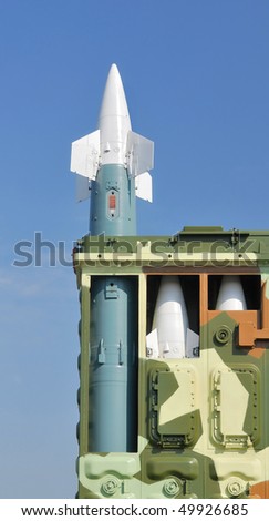 Anti-aircraft defence system. Rocket launcher and rockets in the box against a background of blue sky.