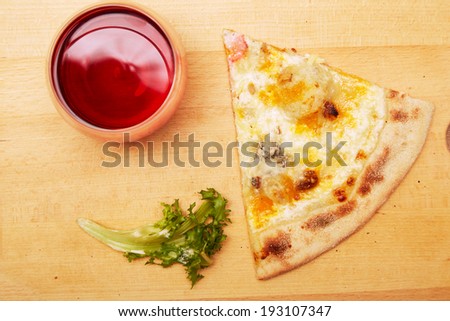 Pizza and wine on wooden table