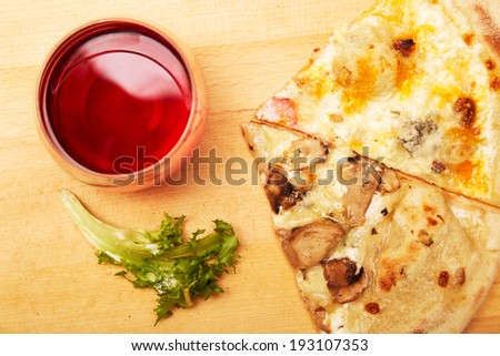 Pizza and wine on wooden table