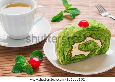 Green tea roll cake and tea cup