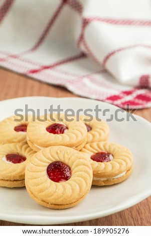 Strawberry jam sandwich biscuits on plate