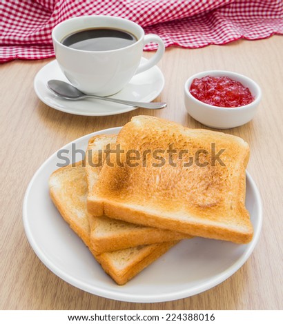 Slice of toasts, jam and coffee cup