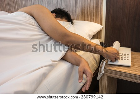 Sleeping man holding a telephone