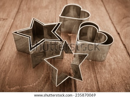 Star shaped and heart shaped pastry cutter on  wooden table