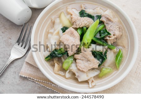 Fried noodle with pork and kale soaked in gravy