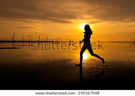 Woman running at sunset silhouette