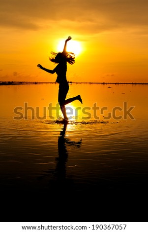 Woman dance at sunset silhouette