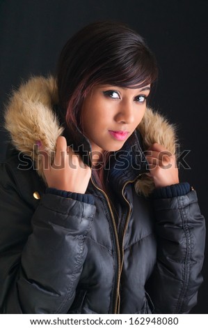 Pretty young woman wearing a faux fur Parka