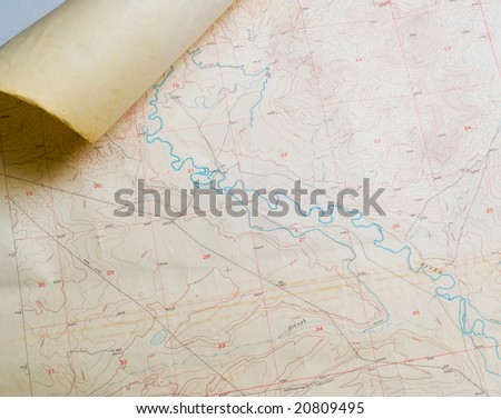Aged topographical map with rolled corner