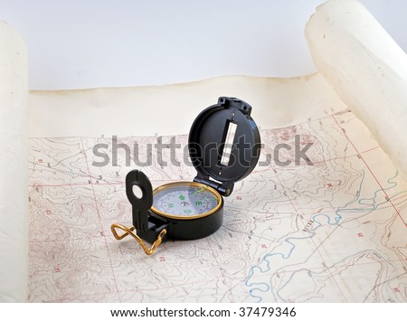 Topographical map with a compass sitting on it.