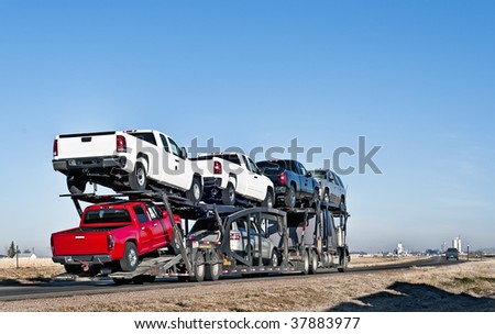 Semi-truck with car hauler or sometimes called a traveling parking lot.