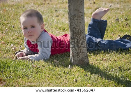 Little boy resting from busy time playing in the back yard.