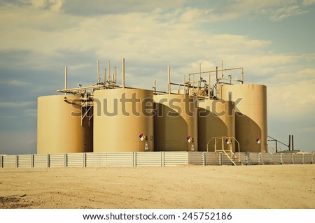 Storage tanks for crude oil in central Colorado, USA. Retro instagram look.
