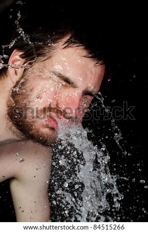 Close-up portrait of man wash her face with water