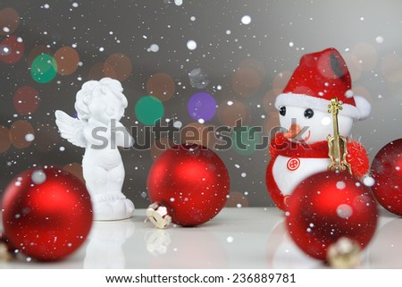 A happy snowman sitting in a winter landscape.