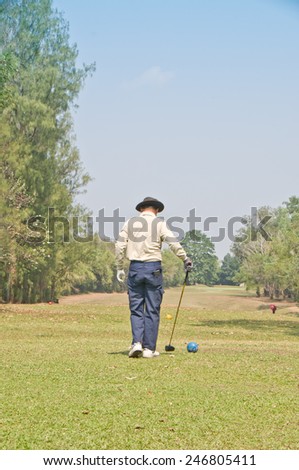 man driving golf on tee off