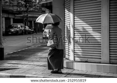 old woman walking in downtown