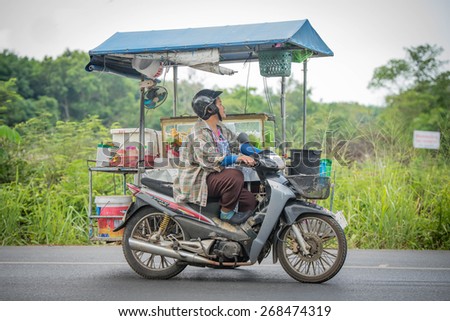 Thailand 11 march 2015, woman ridding Motorcycle Sidecar on road to Tha-mai District in Chantaburi town, Thailand