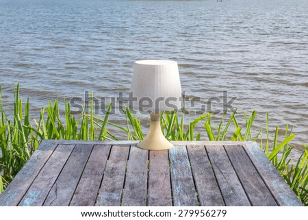 lamp on table beside river