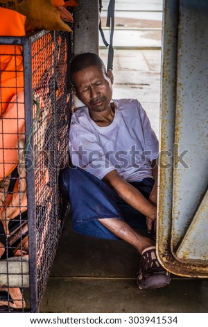 Thailand ,  August 4 2015, a drunk vagrant sleep in boat cabin between going to Koh-Chang Trat province, Thailand