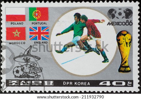 DPR KOREA - CIRCA 1986: a stamp printed by DPR KOREA shows football players and Soccer Pique. 1986 FIFA World Cup football in Mexico, series, circa 1986