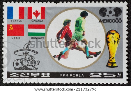 DPR KOREA - CIRCA 1986: a stamp printed by DPR KOREA shows football players and Soccer Pique. 1986 FIFA World Cup football in Mexico, series, circa 1986