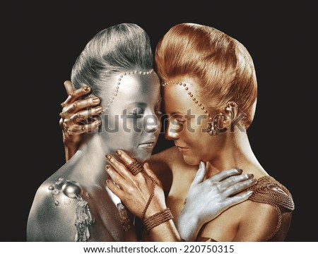 Gilt and silvered. Coloring. Two embracing Women with Paintbrush. Golden and silver Makeup.