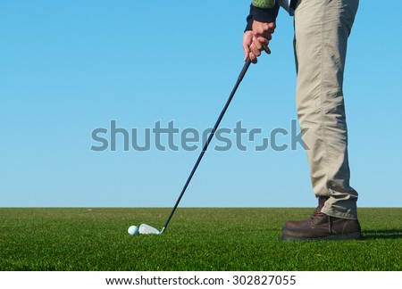 Man playing a game of golf outside