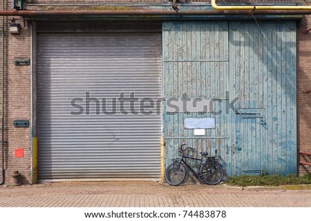 old factory door with bicycle parked in front