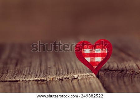 Red valentine\'s day holiday heart  on wooden background with vintage instagram toning