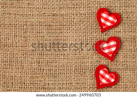 Red valentine\'s day holiday hearts  on retro textile background